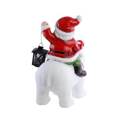 13592 decoration resine pere noel avec lanterne metal sur ours blanc