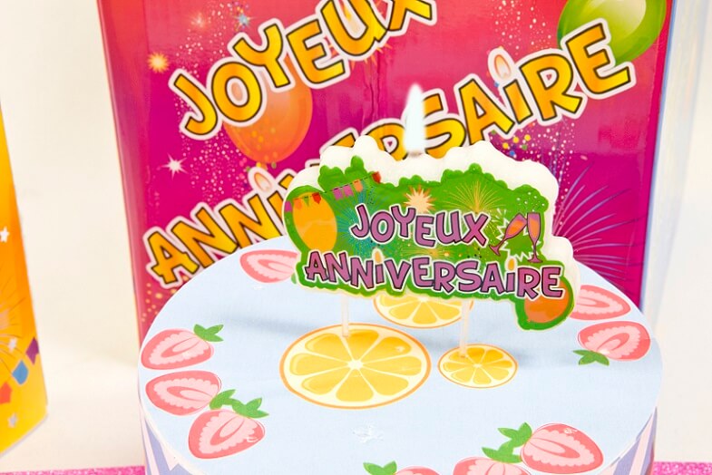 Bougie joyeux anniversaire multicolore sur plaque